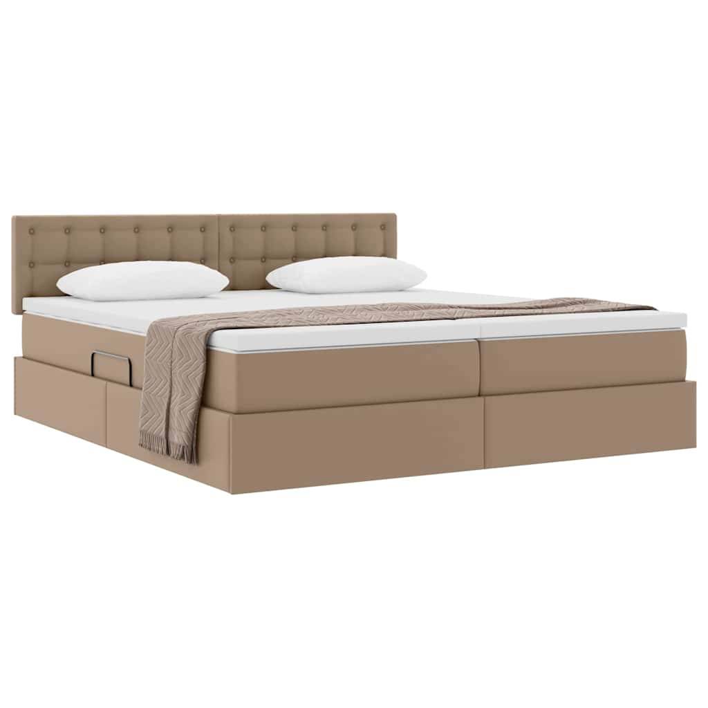 Ein braunes Plattformbett mit gepolstertem Kopfteil, zwei weißen Kissen und einer beige Decke, die am Fußende des Bettes gefaltet ist.