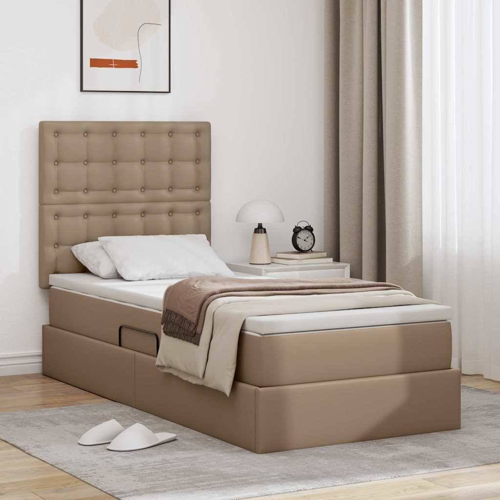 Modernes Schlafzimmer mit beigem gepolstertem Bett, weiß-brauner Bettwäsche, Nachttisch mit Lampe, Wandkunst darüber und Vorhang am Fenster.