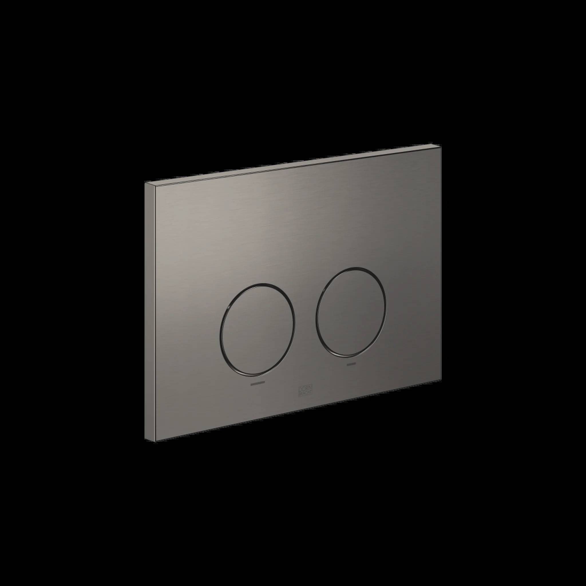 Gebürstete Metallwandhalterung mit Dual-Flush-Platte mit zwei kreisförmigen Tasten auf schwarzem Hintergrund.