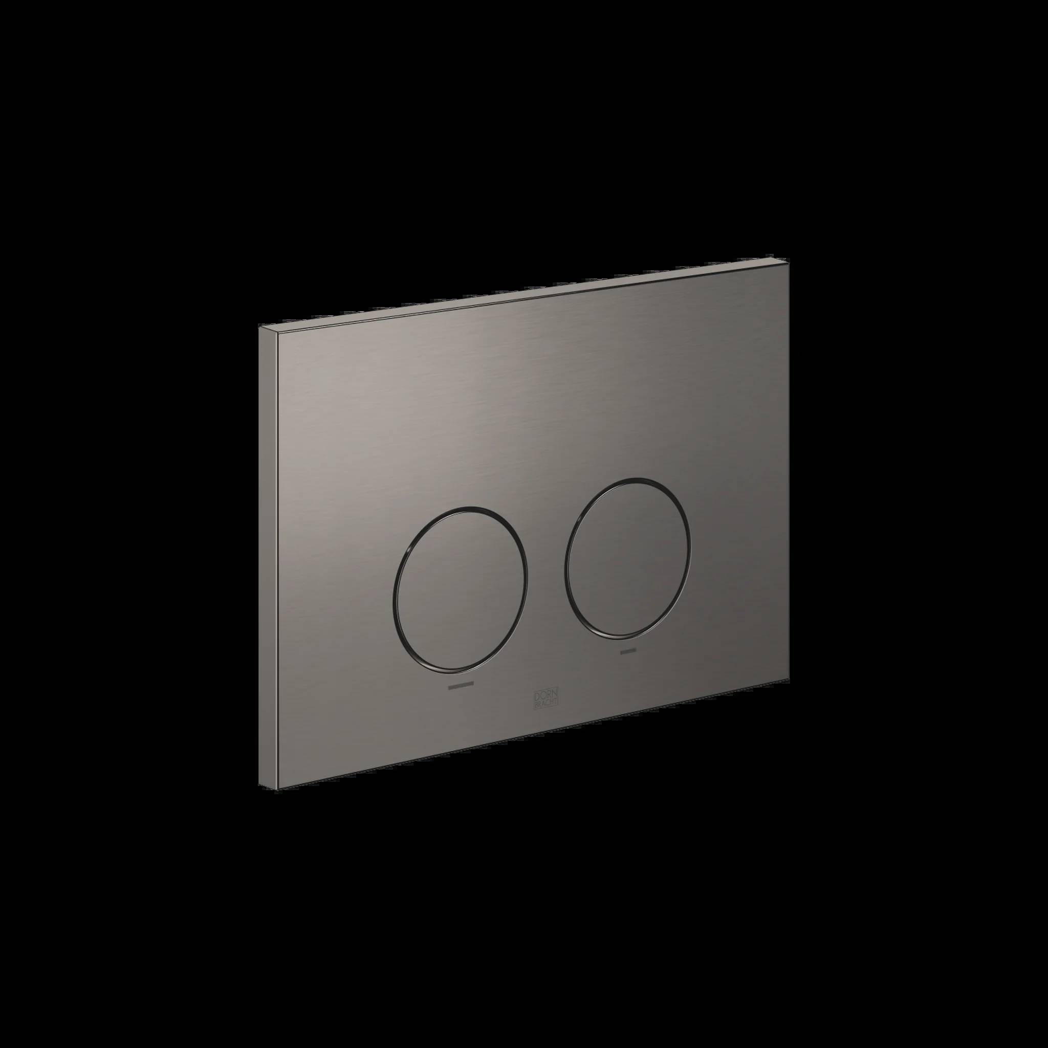 Gebürstetes Metall Dual-Flush-Toilettenknopfpanel mit zwei runden Druckknöpfen auf schwarzem Hintergrund.