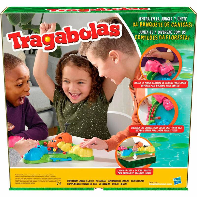 Kinder spielen aufgeregt ein farbenfrohes Tischspiel mit Flusspferd-Figuren, die versuchen, Murmeln zu fressen. Die Spielschachtel trägt die Aufschrift „Tragabolas".