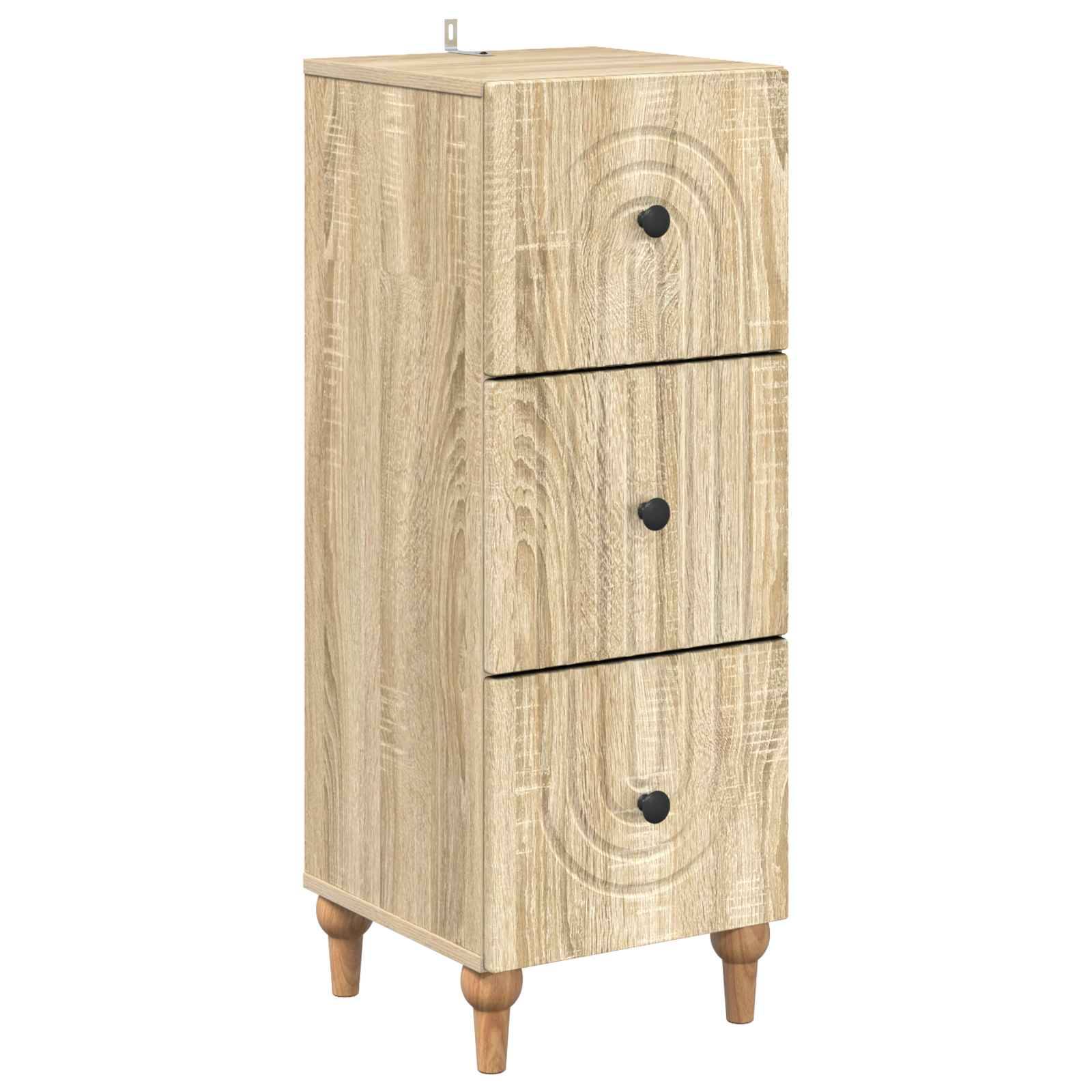 Ein hohes Schrank aus hellem Holz mit drei Schubladen, schwarzen Griffen und verjüngten Beinen, gezeigt auf weißem Hintergrund.