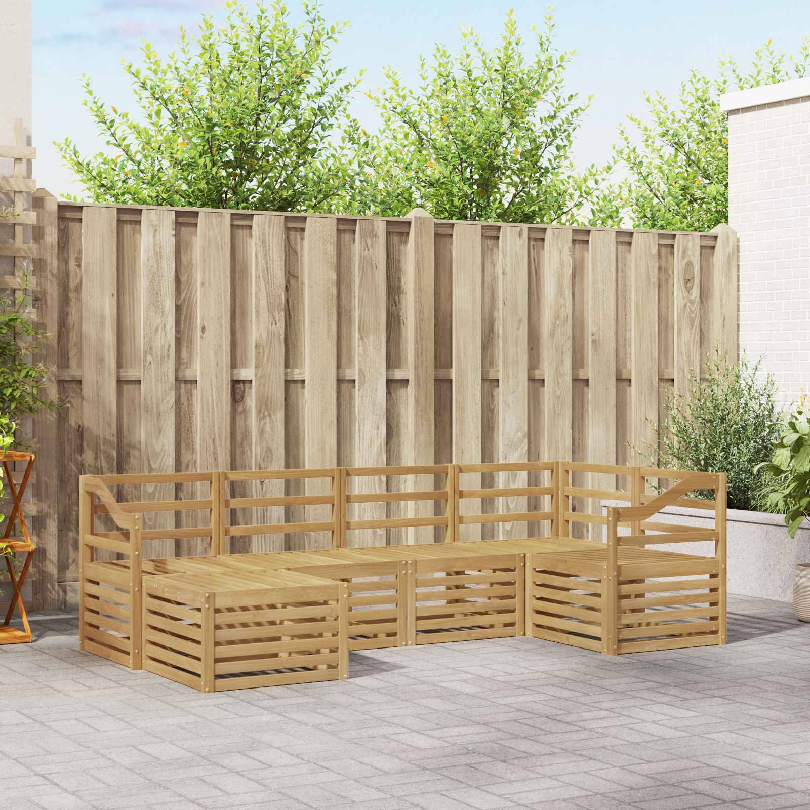 Holzmodulare Außensektionalbank mit niedriger Rückenlehne und Seitenschienen auf einer gepflasterten Terrasse vor einem Holzzaun angeordnet.