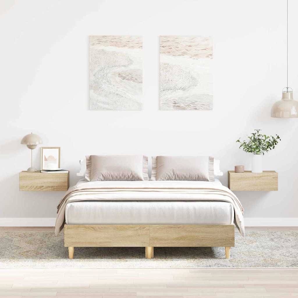 Minimalistisches Schlafzimmer mit hellem Holzbett, neutraler Bettwäsche, passender Wandkunst, Nachttischen, Lampen und einer Pflanze vor einer weißen Wand.