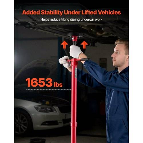 Mechaniker verwendet eine rote Stützstange unter einem gehobenen Auto; der Text besagt „Zusätzliche Stabilität unter gehobenen Fahrzeugen" und „1653 lbs"", zeigt die Unterfahrzeug-Tragfähigkeit.