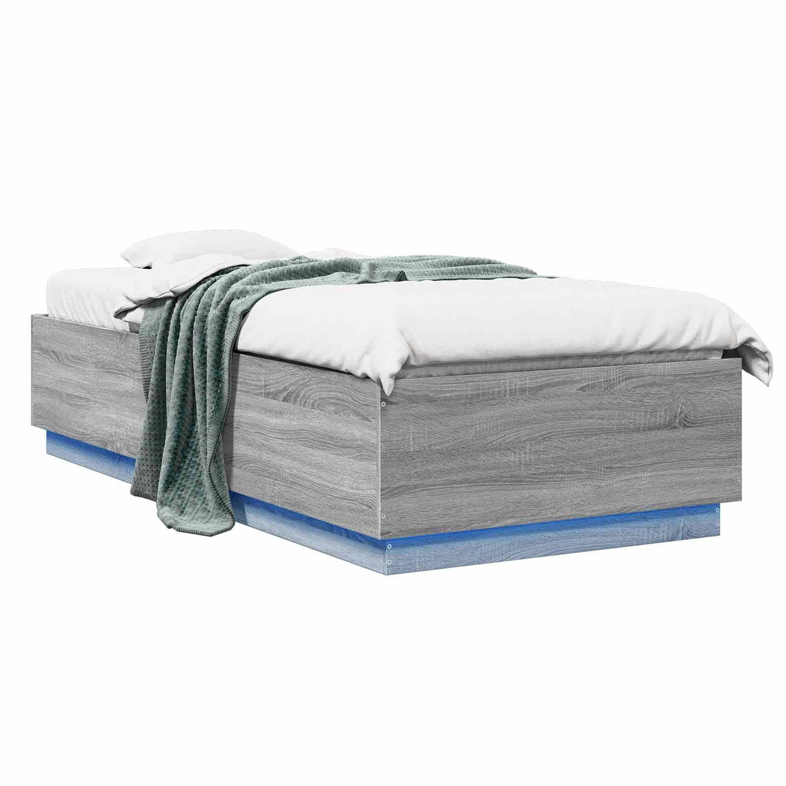 Grau gepolstertes Plattformbett mit weißer Bettwäsche und einer grünen Wurfdecke, dargestellt auf weißem Hintergrund.