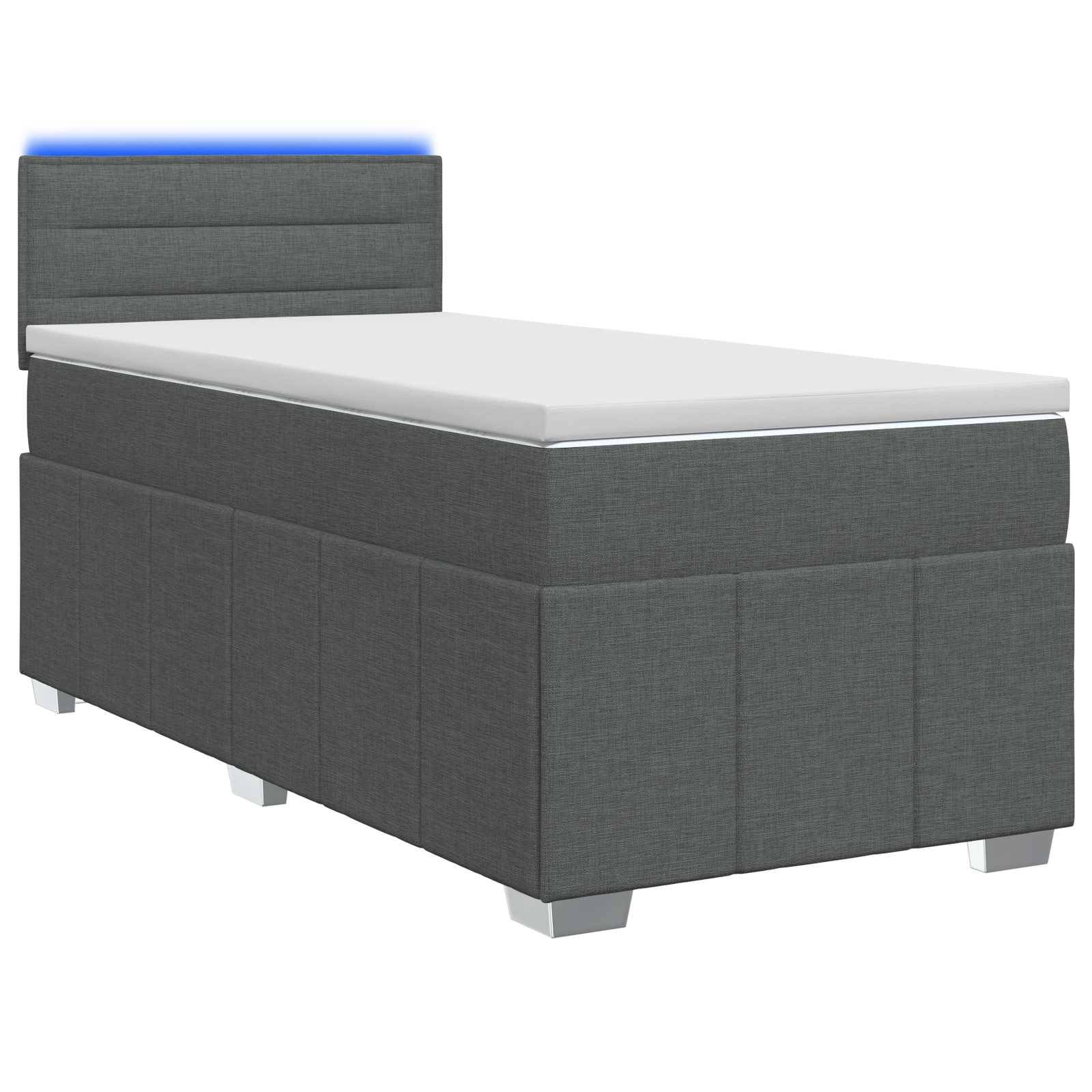 Grau gepolstertes Einzelbett mit Matratze und gepolstertem Kopfteil, dargestellt vor weißem Hintergrund mit subtiler blauer Beleuchtung hinter dem Kopfteil.