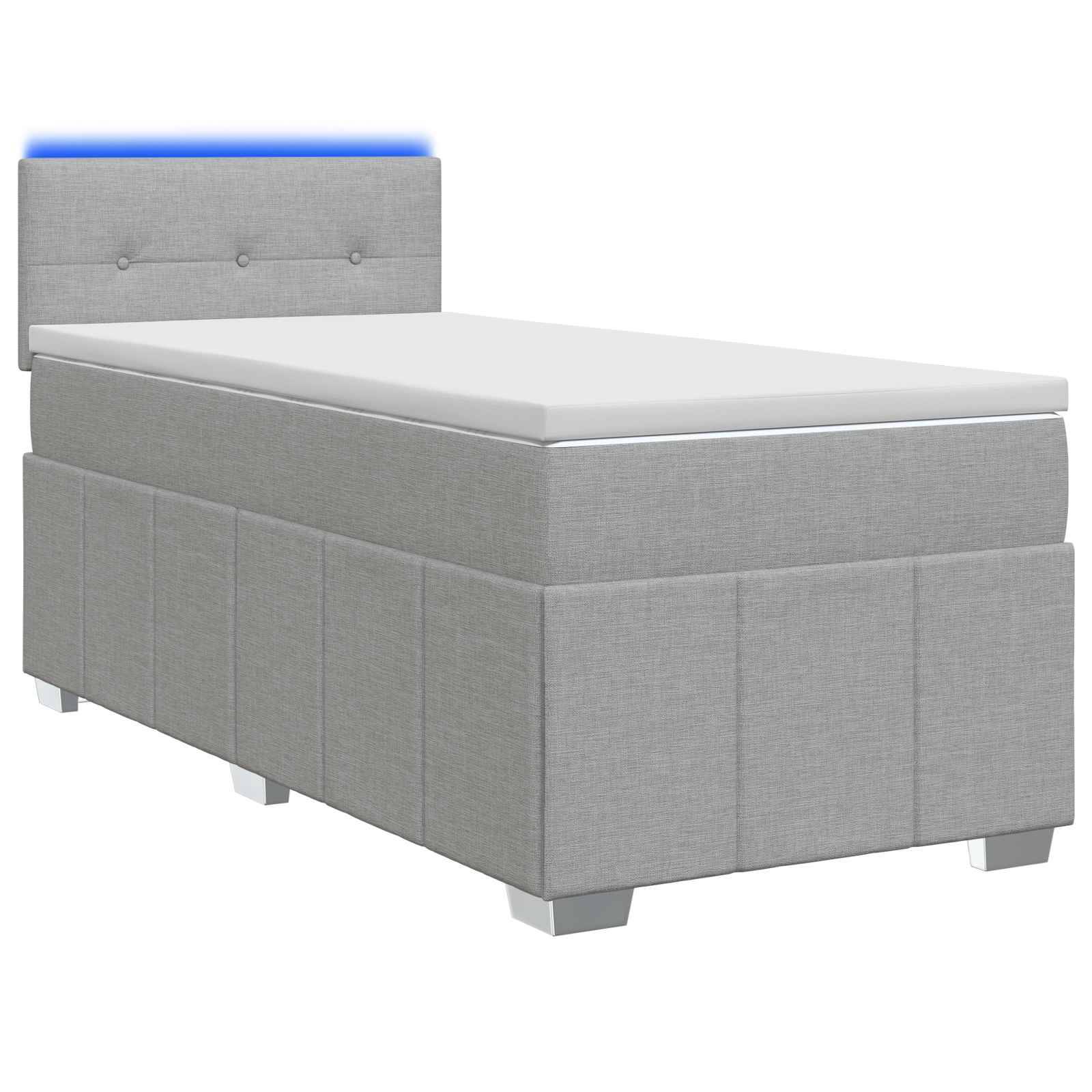 Grau gepolstertes Einzelbett mit gepolstertem Kopfteil und weißer Matratze auf einfachem weißem Hintergrund.