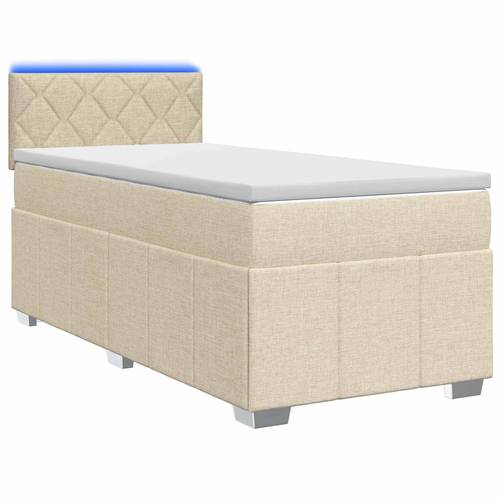 Beige gepolstertes Einzelbett mit Matratze und gepolstertem Kopfteil auf weißem Hintergrund.