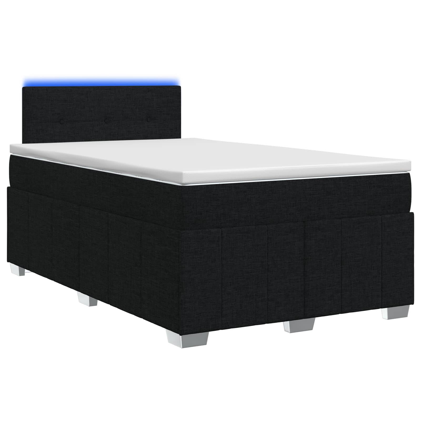 Schwarzes gepolstertes Einzelbett mit weißer Matratze und blau beleuchteter Kopfstütze auf einem einfachen weißen Hintergrund.