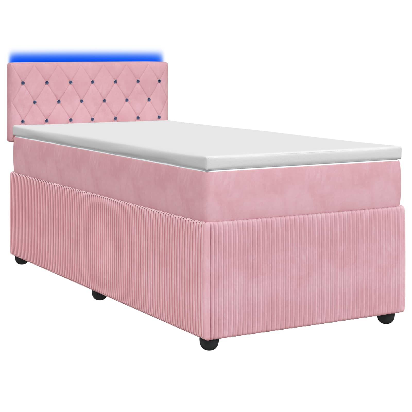 Einzelbett mit rosa Polsterung, getufteter Kopfstütze und weißer Matratze auf neutralem weißem Hintergrund.