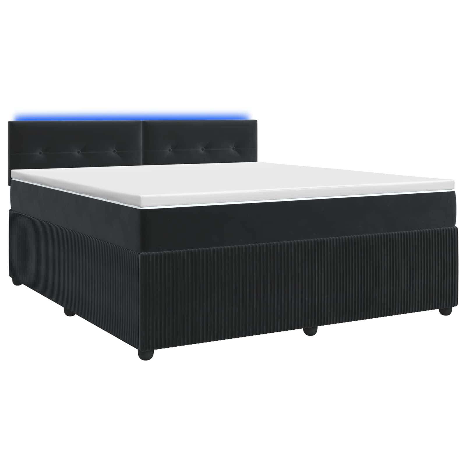 Schwarzes gepolstertes Bett mit weißer Matratze und blau beleuchteter Kopfleiste auf weißem Hintergrund.