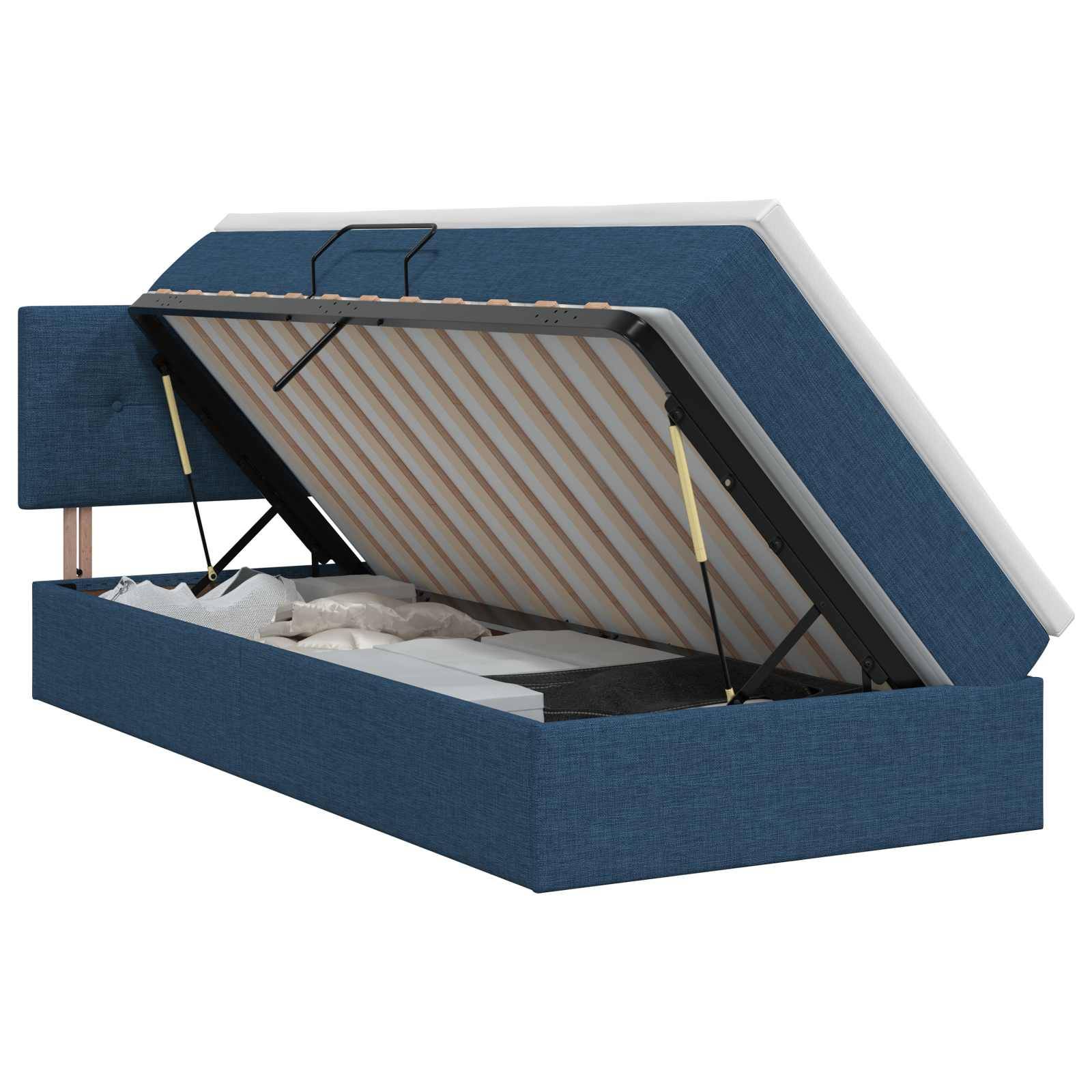 Blaugepolstertes Speicherbett mit angehobener Matratzenunterlage, das das Unter-Bett-Speicherfach und das Stützgestell zeigt.