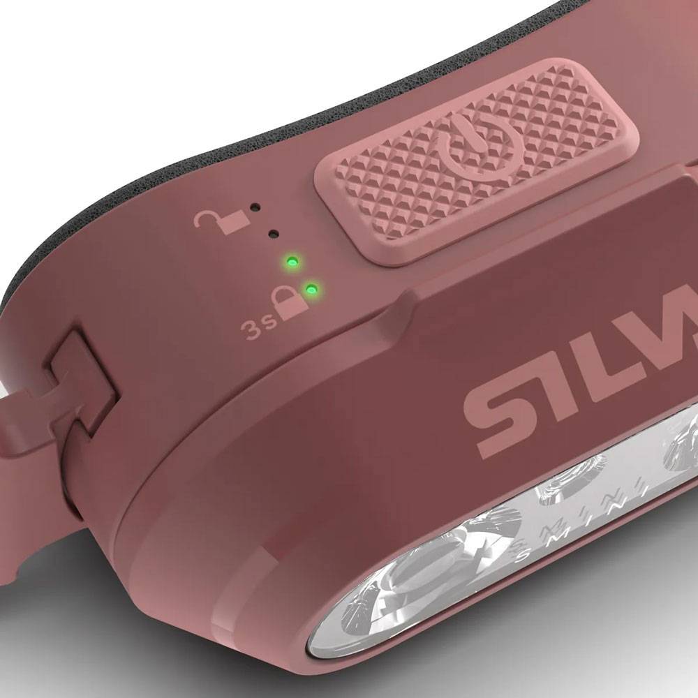 Nahaufnahme einer rosa SILVA-Stirnlampe mit Verriegelungsindikatoren, zwei grünen Status-LEDs und der vorderen Lichtlinse.