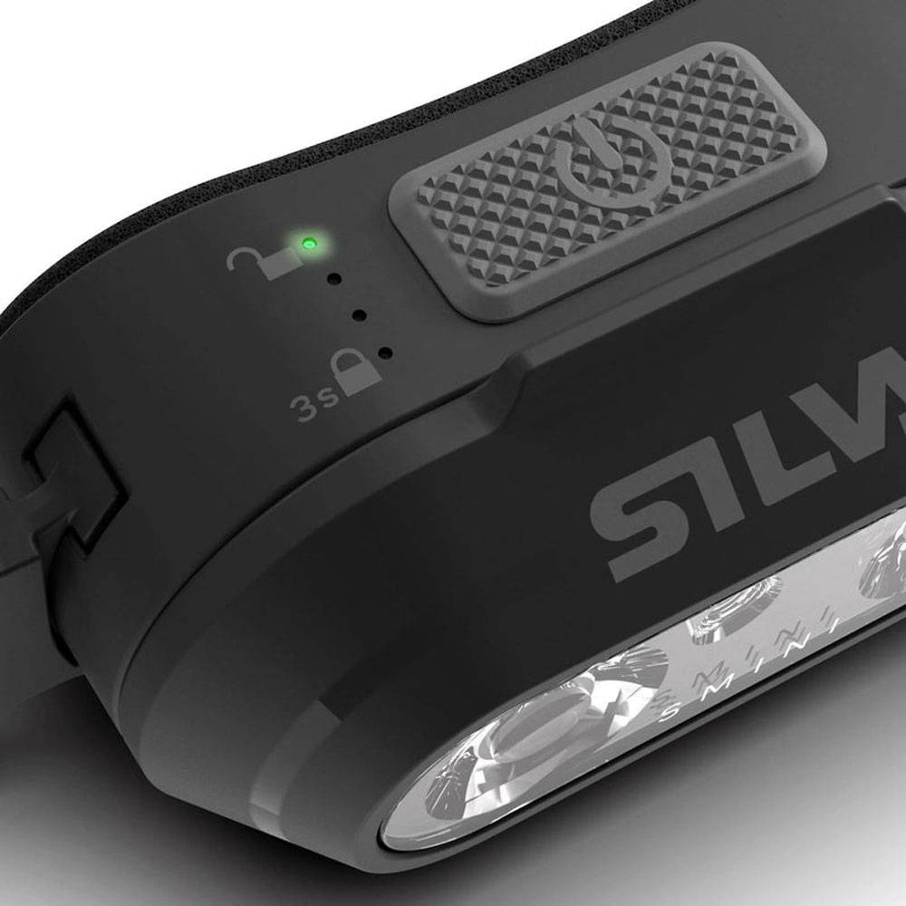 Nahaufnahme einer schwarzen SILVA-Stirnlampe mit strukturierter oberer Taste, grüner Statusleuchte, Schlosssymbolen und einer vorderen LED-Linse.