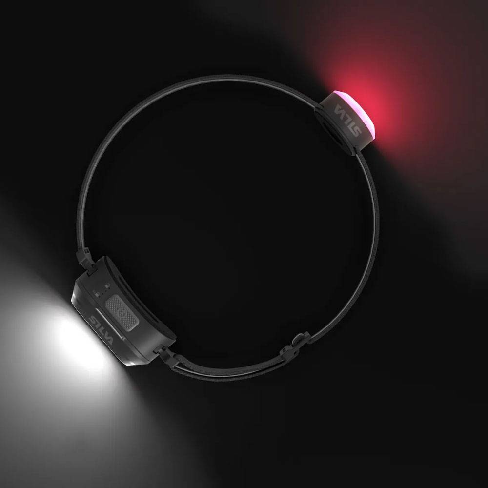 Schwarzes verstellbares Stirnlampenband mit weißem Licht auf einer Seite und rotem Licht auf der anderen Seite, gezeigt auf dunklem Hintergrund.