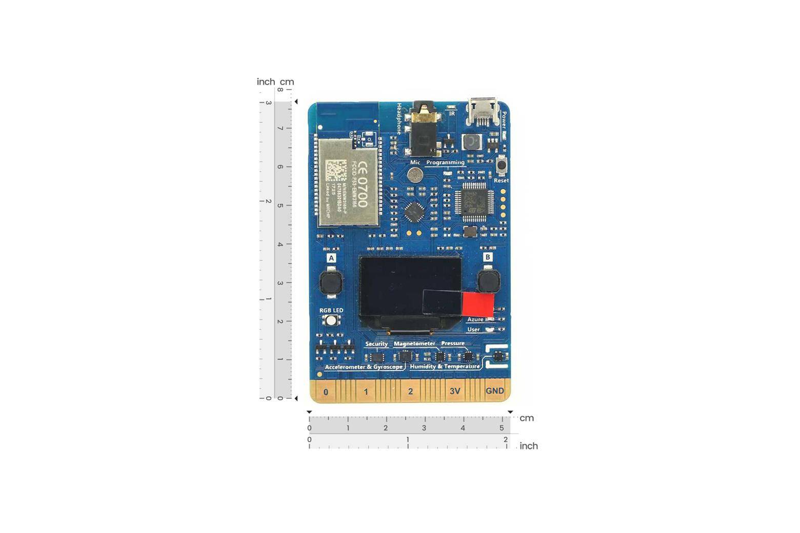 Blaue elektronische Platine, die gegen Zoll- und cm-Lineale zur Größenreferenzierung gezeigt wird, mit LCD-Bildschirm und gekennzeichneten Anschlüssen/Komponenten.