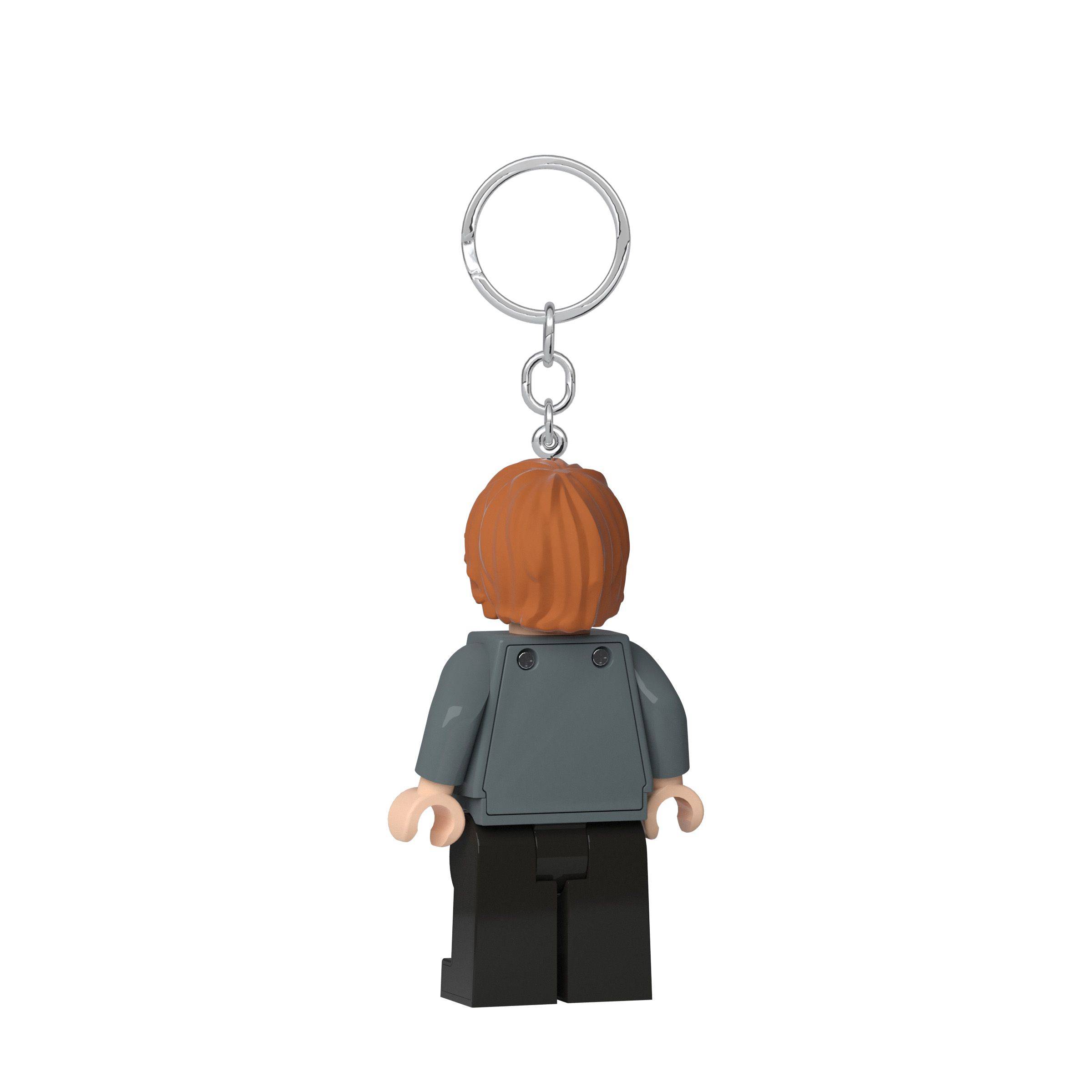 Rückansicht eines LEGO-ähnlichen Minifigur-Schlüsselanhängers mit braunem Haar, grauem Oberkörper und schwarzen Beinen an einem Metallring.
