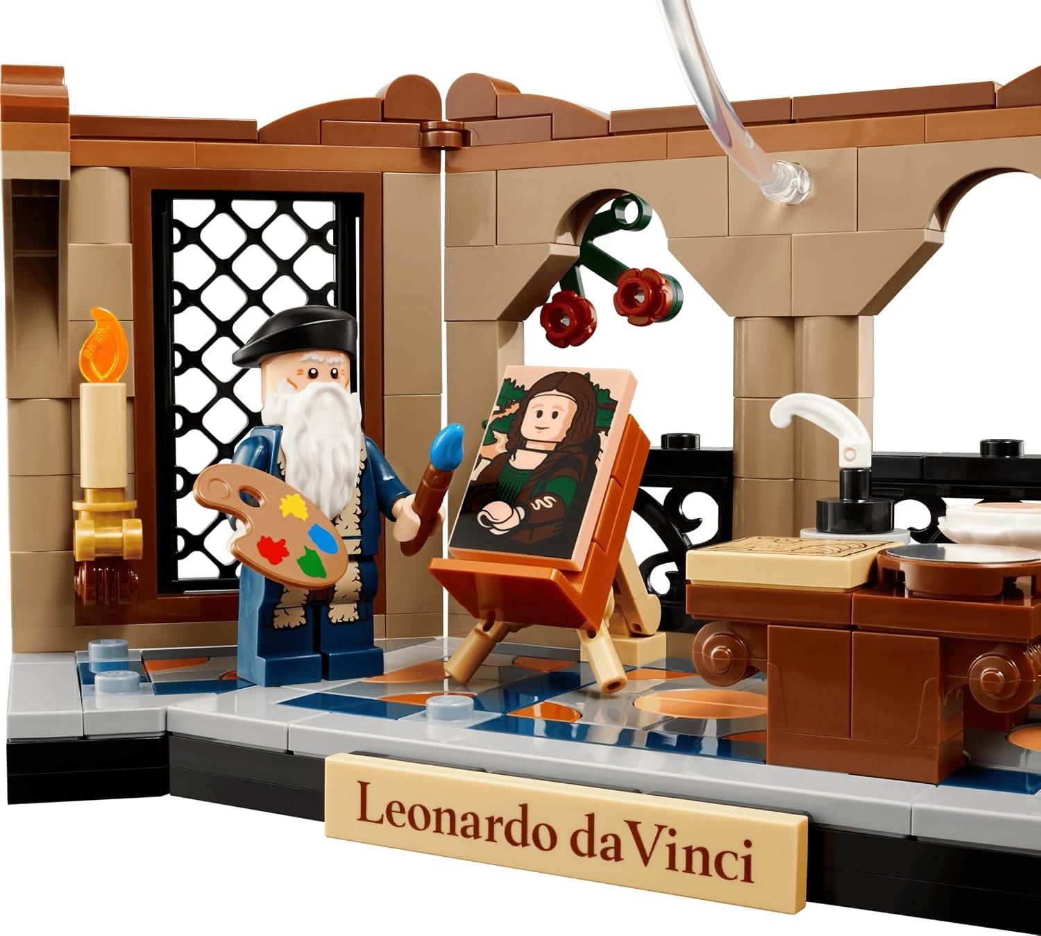 LEGO-ähnliche Szene von Leonardo da Vinci, der an einer Staffelei in einer Werkstatt malt, mit Palette, Pinsel und seinem Namensschild davor.