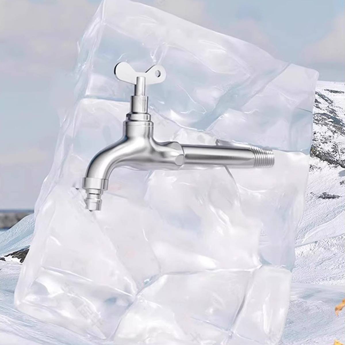 Verchromter Außenwasserhahn montiert auf einem durchsichtigen aufblasbaren Behälter vor einem verschneiten Berggrund.