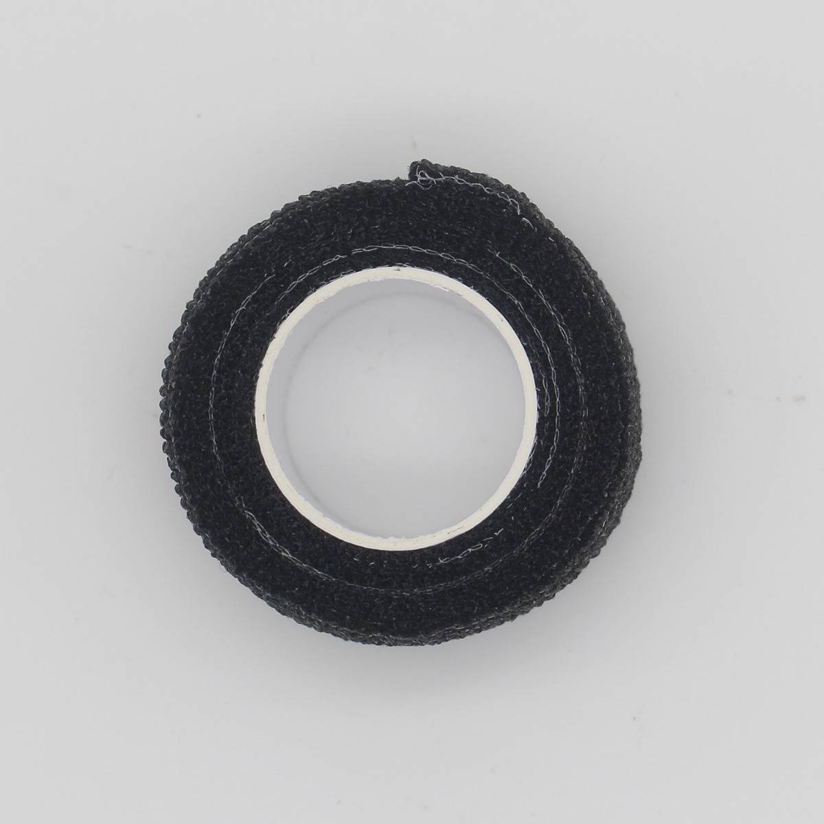 Schwarze Rolle strukturiertes Klebeband von oben auf hellem, unifarbigem Hintergrund.