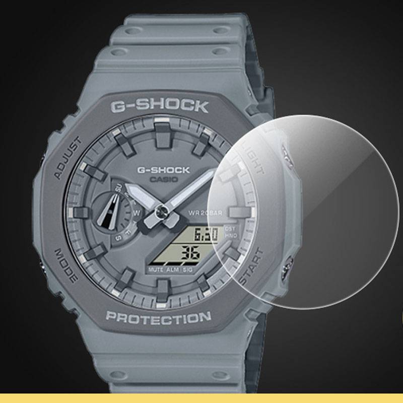 Graue Casio G-SHOCK Armbanduhr von vorne gezeigt, mit analog-digitaler Anzeige, "G-SHOCK""-Branding und einer kreisförmigen vergrößerten Seitenansicht, die das Gehäuse hervorhebt