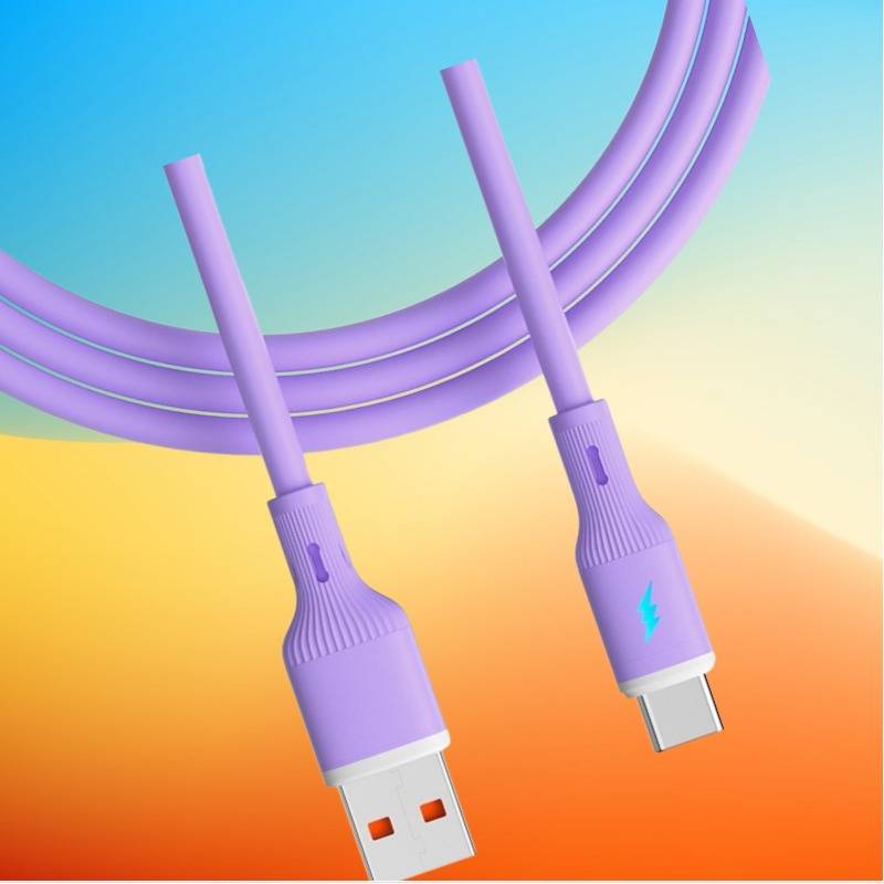 Illustration zweier violetter Ladekabel, eines USB-A und eines USB-C, auf einem blau-zu-orange-Farbverlauf-Hintergrund.