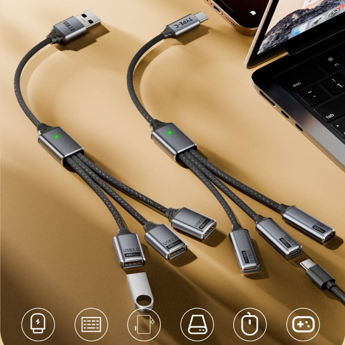 Zwei geflochtene USB-C-Hub-Kabel, die sich neben einem Laptop und einem Telefon in mehrere Stecker aufteilen und mehrgeräteladenund Datenübertragung zeigen.