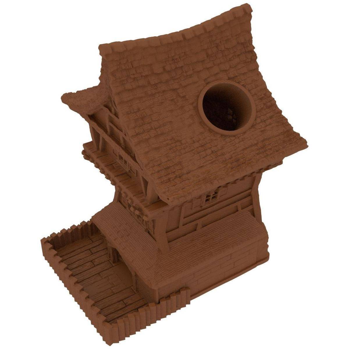 Ein kleines braunes 3D-gedrucktes Hausmodell mit steilem Dach, rundem Dachbodenfenster und angebautem Deck oder einer Terrasse.
