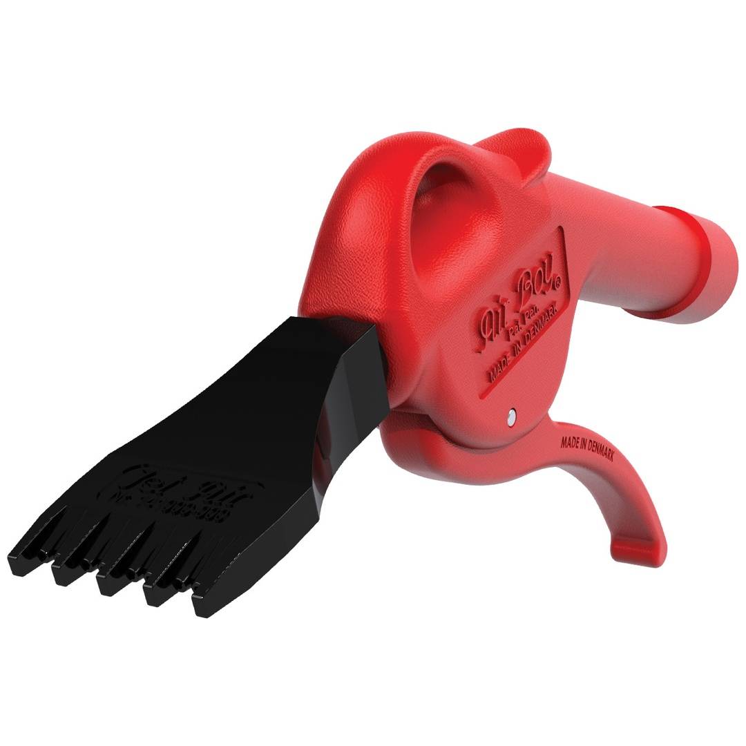 Rotes Kunststoff-Handwerkzeug mit schwarzer kammartiger Aufsatz und gebogenem Griff, auf weißem Hintergrund dargestellt.