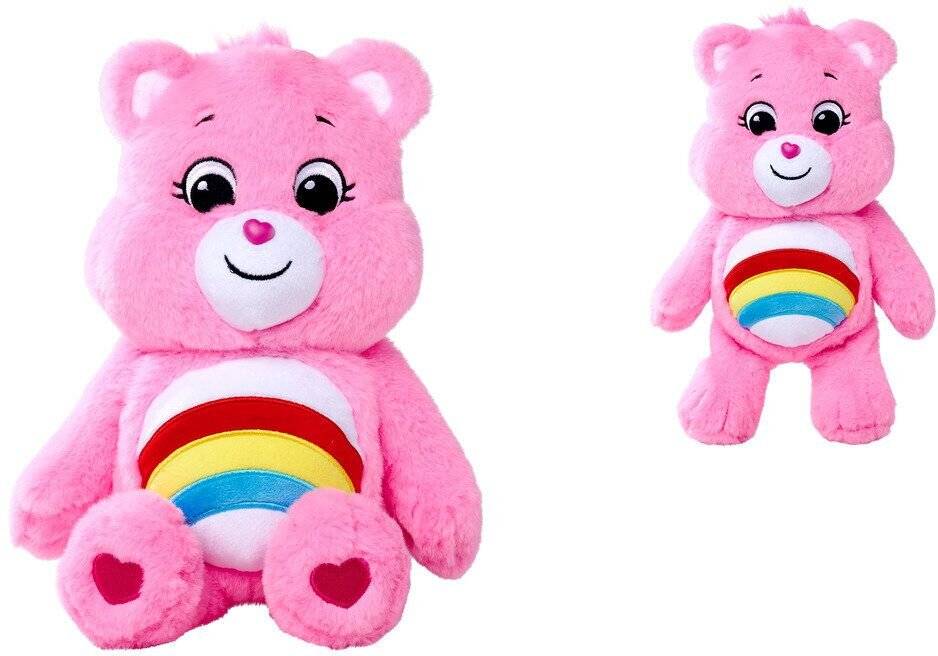 Rosa Plüsch-Teddybär-Spielzeug mit lächelndem Gesicht und Regenbogen auf dem Bauch, gezeigt in zwei Größen auf weißem Hintergrund.