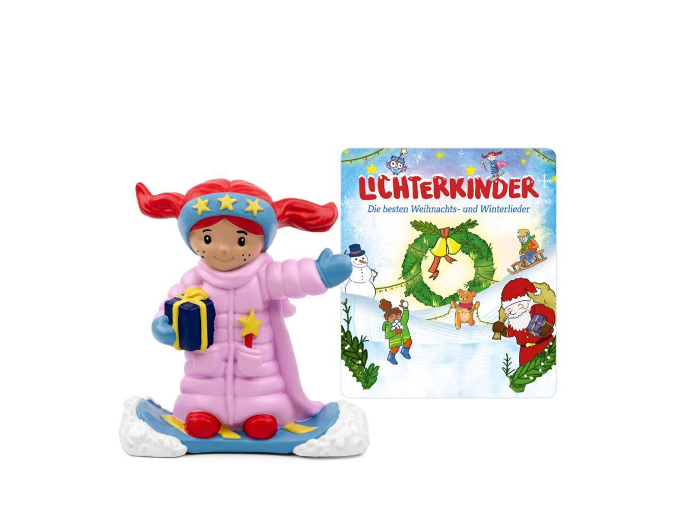 Spielzeugfigur eines lächelnden Mädchens in einem rosa Schneeanzug, das ein Geschenk hält, neben einem 