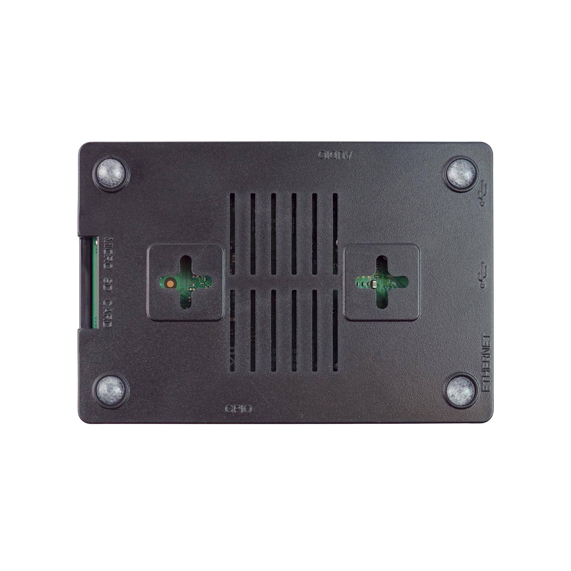 Draufsicht eines kleinen schwarzen elektronischen Gerätgehäuses mit Lüftungsöffnungen, vier Eckschrauben und Ausschnitten, die grüne Schaltungskomponenten im Inneren freilegen.