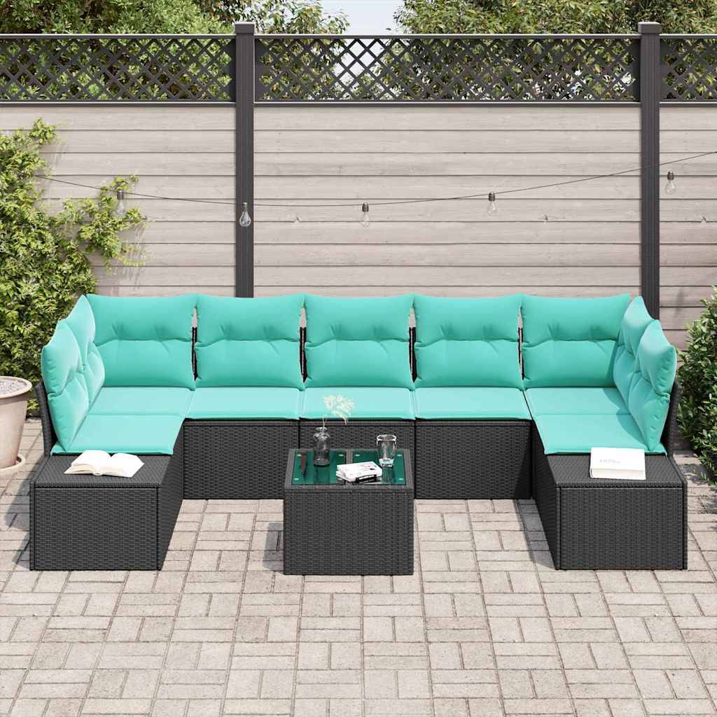 Modulares Außen-Terrassensofaset mit türkisen Kissen und schwarzen Rattantischen auf einer gepflasterten Terrasse vor einem Holzzaun.