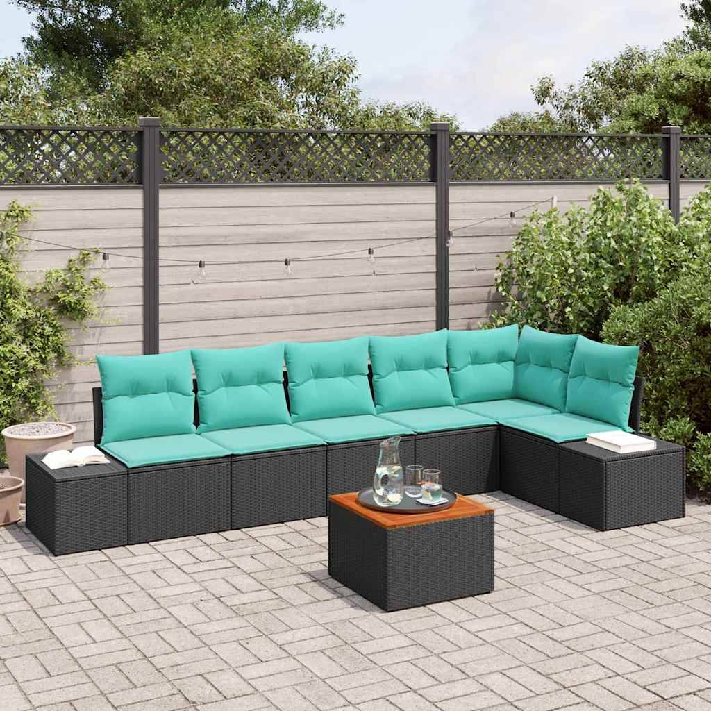 Outdoor-Terrasse mit schwarzem Ecksofa und türkisfarbenen Kissen um einen kleinen Couchtisch, auf einer gepflasterten Terrasse mit Pflanzen und Zaun im Hintergrund.
