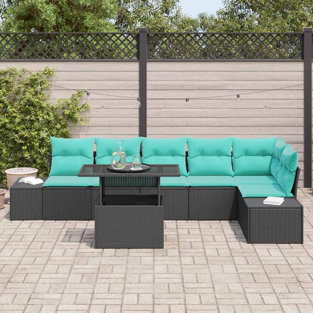 Außenbereich-Sitzmöbelset mit türkisfarbenen Kissen, schwarzes Rattan-Ecksofa und passendem Tisch auf einer gepflasterten Terrasse gegen einen Zaun.