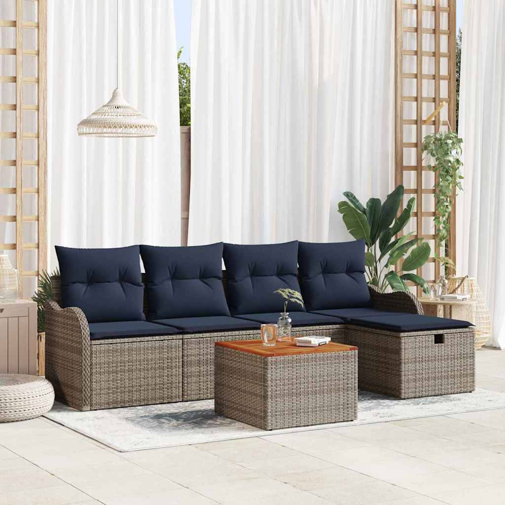 Modernes Outdoor-Sitzgarnitur mit gewebtem Rattan-Ecksofa, marineblauen Kissen, passendem Ottomane-Tisch und hängender Lampe in einer hellen verglasten Veranda.