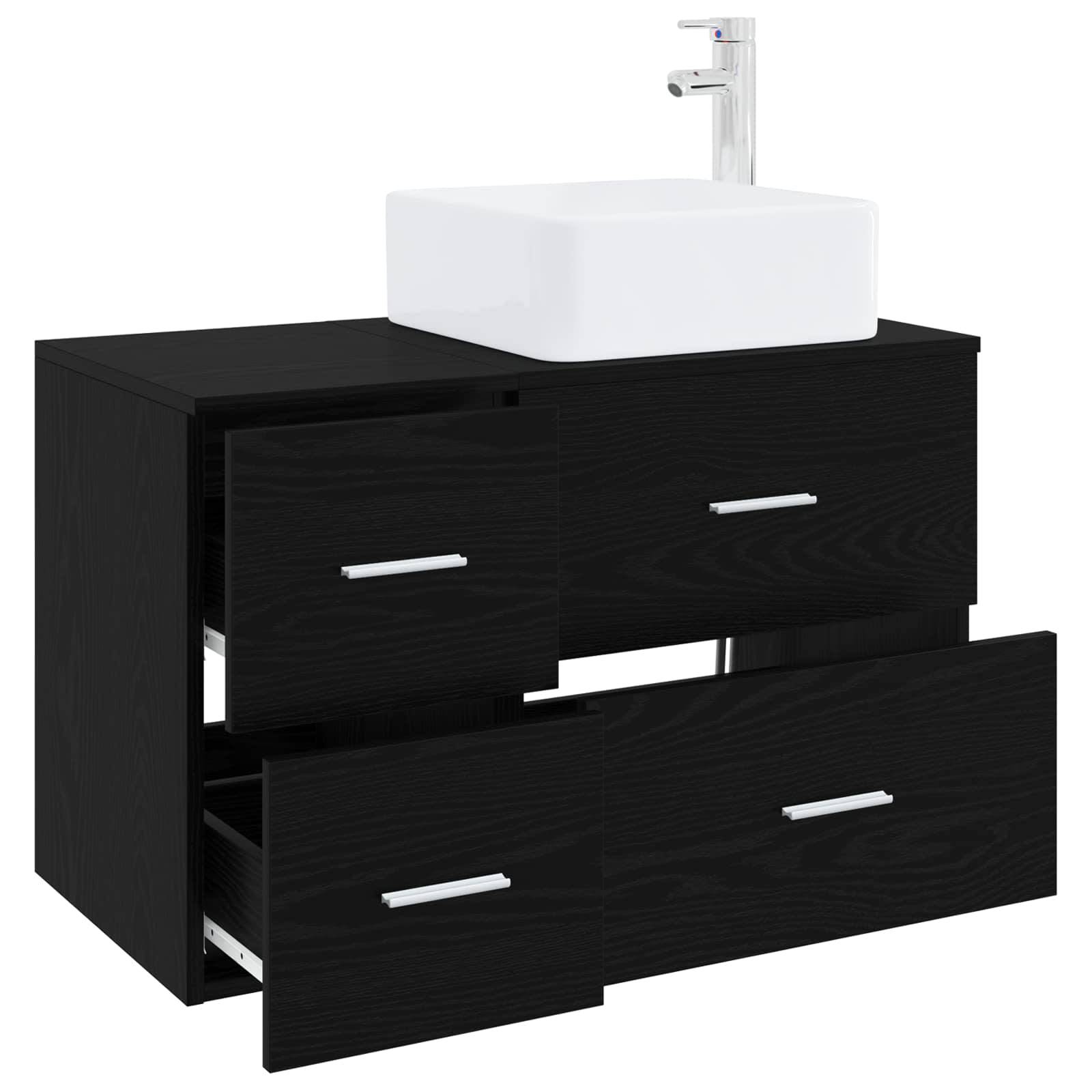 Schwarzes Badezimmer-Waschtisch mit weißem Aufsatzbecken und Chromarmatur, mit drei Schubladen zur Aufbewahrung.