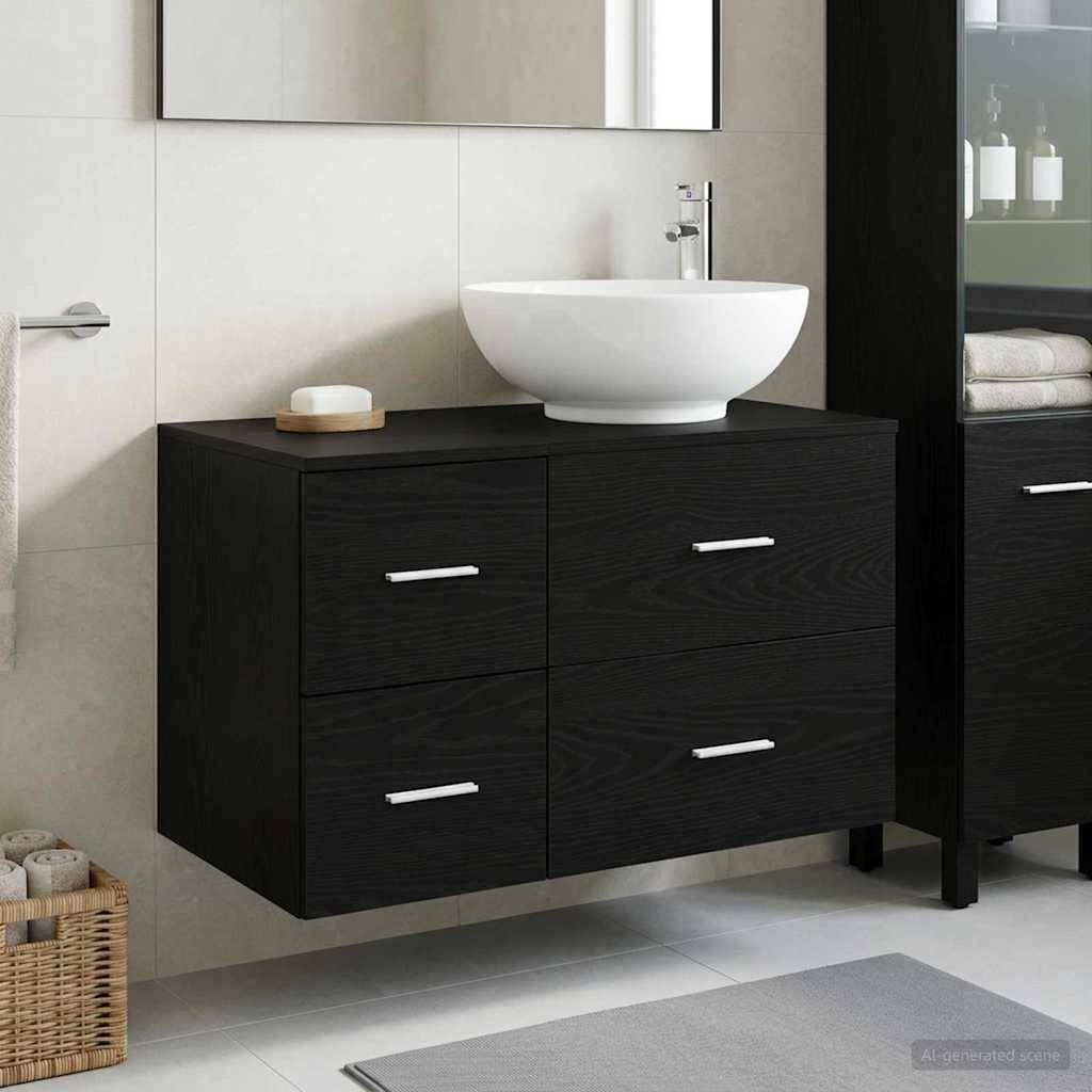 Modernes Badezimmerwaschtisch mit einem weißen Aufsatzwaschbecken auf einem schwarzen Schrank, gezeigt neben einem Spiegel und einer gefliesten Wand.