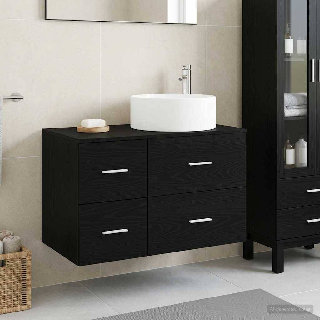 Modernes Badezimmerwaschbecken mit weißem Aufsatzwaschbecken auf einem schwarzen Schrank mit vier Schubladen, neben einem passenden hohen Lagerschrank.