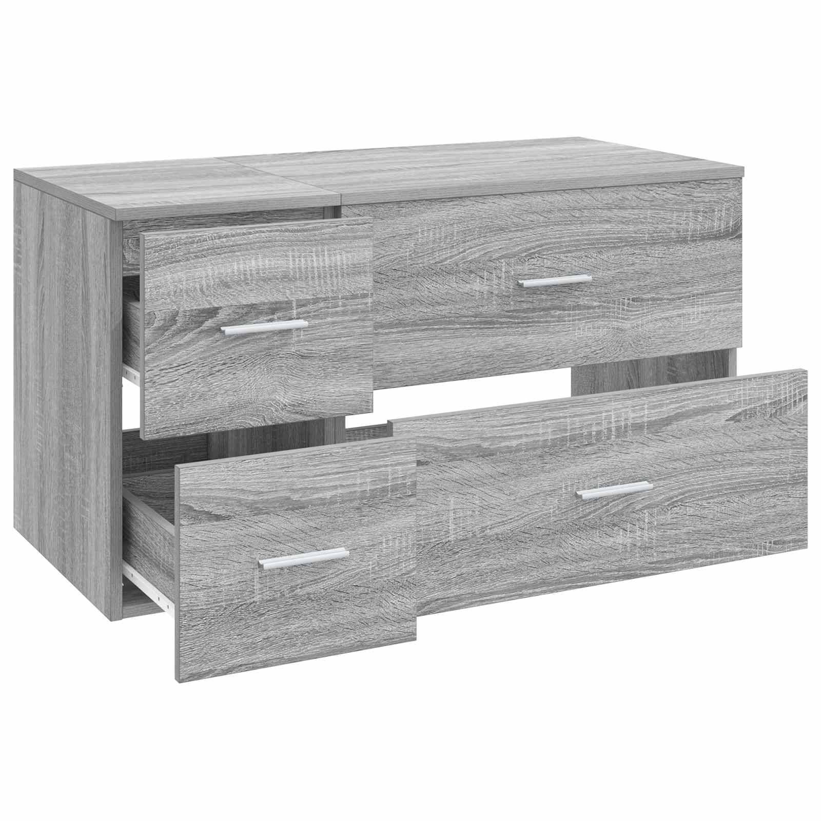Graue Holzkommode mit drei Schubladen, eine kleine obere linke Schublade teilweise offen und eine große untere Schublade herausgezogen, auf weißem Hintergrund.