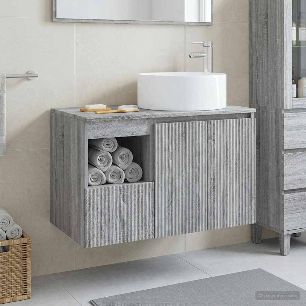 Modernes Badezimmer-Waschtisch mit rundem weißem Waschbecken, grauem strukturiertem Schrank und offener Handtuchablage in einem gefliesten Zimmer