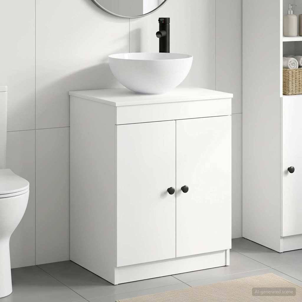 Weißer Badezimmerschrank mit Aufsatzwaschbecken und schwarzem Wasserhahn in einem modernen gefliesten Badezimmer.