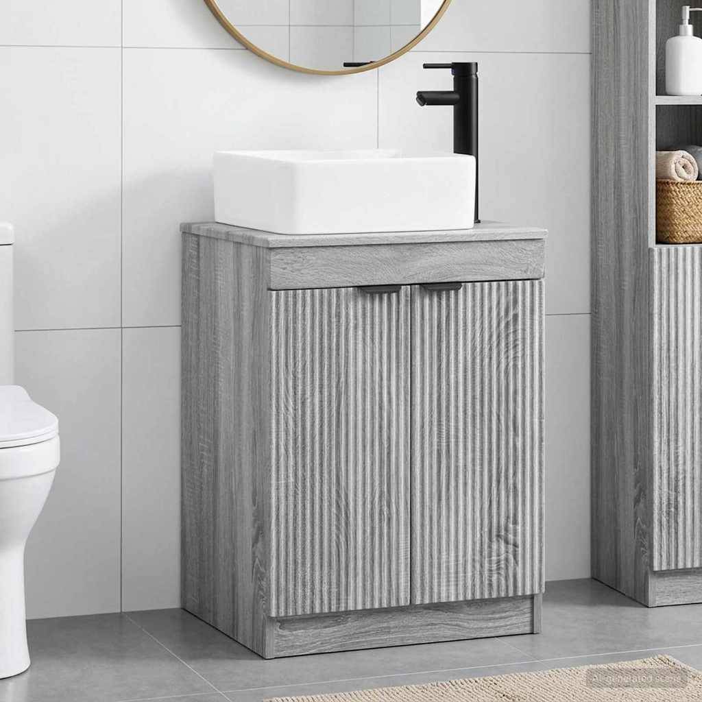Modernes Badezimmer-Waschtischschrank mit weißem Aufsatzwaschbecken und schwarzem Wasserhahn, gezeigt vor weißen gefliesten Wänden und grauem Bodenbelag.