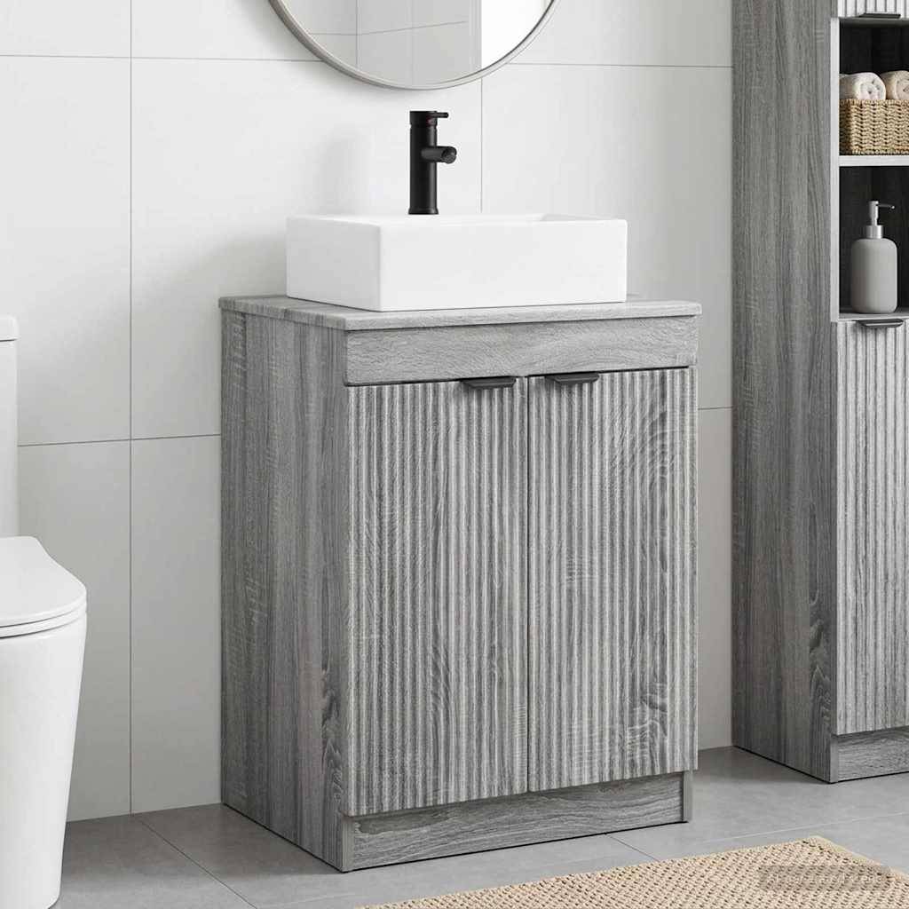 Grauer Holz-Waschtisch mit weißem quadratischem Waschbecken und schwarzem Wasserhahn neben einer Toilette, gezeigt in einem modernen gefliesten Badezimmer.