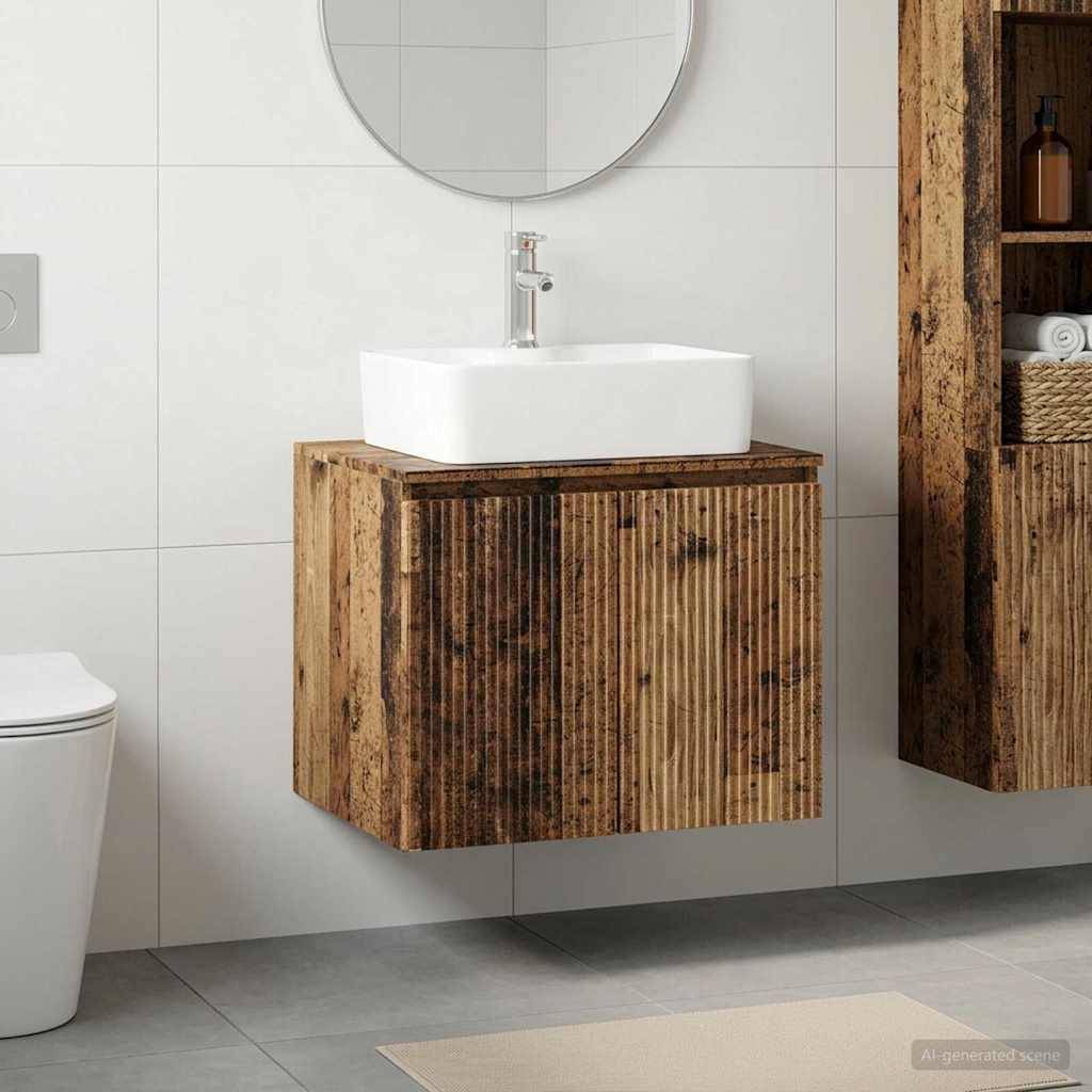 Modernes Badezimmer-Waschtisch mit weißem Aufsatzwaschbecken und rundem Spiegel über einem schwebenden Holzschrank; Toilette teilweise links sichtbar.