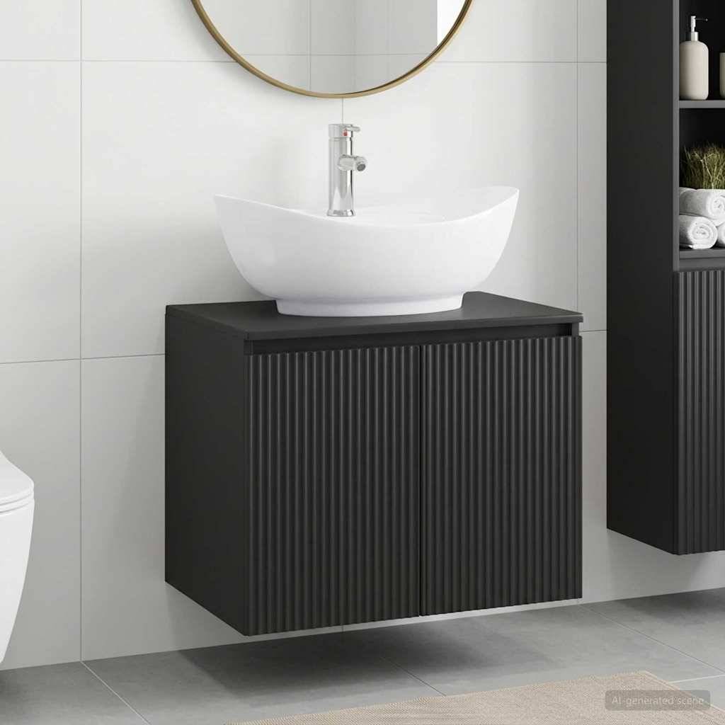 Modernes Badezimmer-Waschbecken mit weißem Aufsatzwaschbecken und Chromarmatur auf einem an der Wand montierten schwarzen Schrank unter einem runden Spiegel.