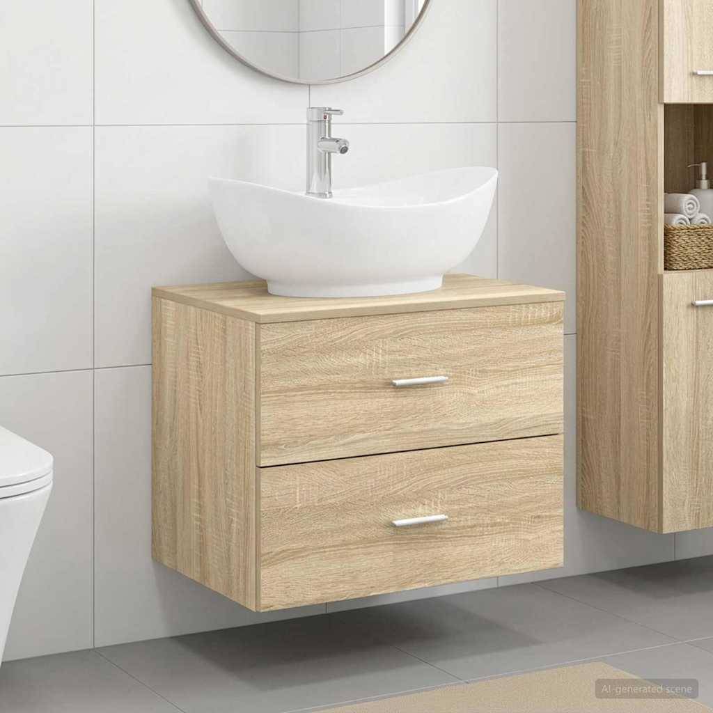Modernes Badezimmermöbel mit einem weißen Aufsatzwaschbecken auf einem hellholzfarbenen Unterschrank mit zwei Schubladen, dargestellt vor gefliesten Wänden und grauem Boden.