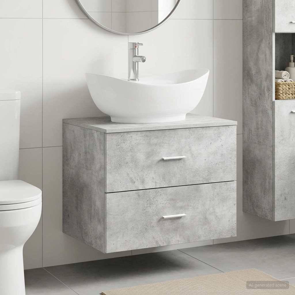Modernes Badezimmer-Waschtisch mit weißem Aufsatzwaschbecken, rundem Spiegel und zweieinhalb Betonoptik-Schrank neben einer Toilette.