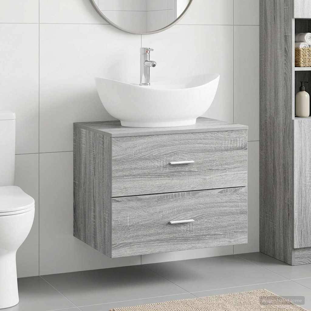 Modernes Badezimmermöbel mit an der Wand montiertem grauem Holzschrank, weißem Aufsatzwaschbecken, rundem Spiegel und Toilette sichtbar auf der linken Seite.